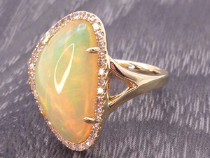 lot 22 image: Upscale and Classy Large Natural Opal and Diamond Halo Estate Ring in 14k Yellow Gold
