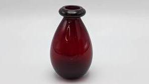 lot 423 image: Red Glass Trio- Ruby Red Bottle, Swung Art Glass Vase, Red on White Cased Fenton Vase