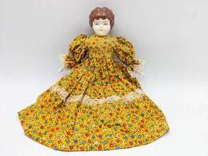 lot 219 image: Meg Tudor Porcelain Doll Dressed with Handmade Doll Clothes