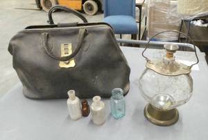 lot 39 image: Vintage doctors bag some bottles and a decanter that is musical and plays How dry I am