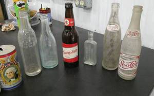 lot 76 image: vintage pop bottle collection in metal milk crate 7up, coke, pepsi, jacob ries-shakopee, hauenstein beer