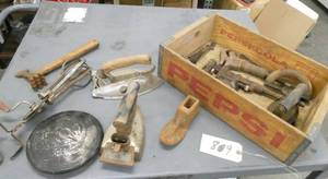 lot 89 image: Wood Pepsi crate with various vintage items, irons, pipe wrenches, wheel cover etc