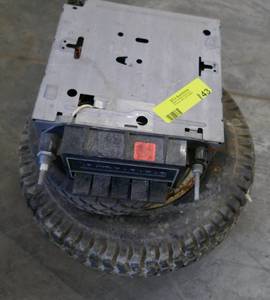 lot 143 image: old car radio and 2 small wheels (lawn mower and 13x5)