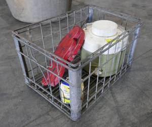 lot 146 image: metal milk crate with a couple of butterfly garden ornaments, a water jug and a spark plug cleaner