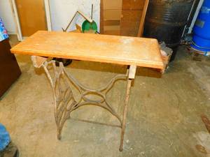 Wooden Table On A Metal Ornamental Base