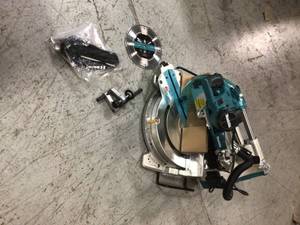 lot 104 image: 15 Amp 10 in. Dual Bevel Sliding Compound Miter Saw with Laser by Makita Customer Returns See Pictures