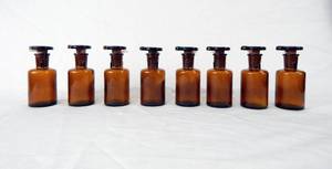 lot 192 image: Set of 8 Vintage 60 ML T.C.W. Company Amber Glass Dropping Bottles With Grooved Stoppers