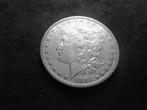 lot 13 image: 1884 S Morgan Silver Dollar