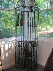 lot 29 image: Tall & round metal Wine Rack. 