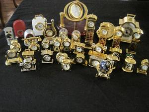 lot 98 image: A collection of 34 mini clocks and 1 mini globe. 