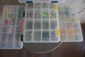 4 Storage Containers With Assorted Jigs and Artificial Bait