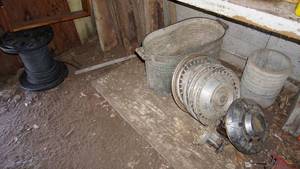 lot 23 image: 14 Hose---Wooden Four Gun Rack---Hub Caps---Antique Metal Container
