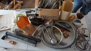 lot 169 image: An Antique Atlas -Black & Decker Car Vacuum-Door Knob That Locks W Key-Grass Seed-Regina Dirt Magnet Hand Vacuum-Hangers-Aluminum Foil Tape-Faucet Valve Stop-Small Garbage Can