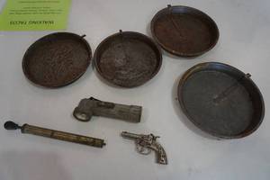 Vintage pie tins, air pump, military flashlight and toy gun