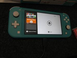 lot 128 image: Nintendo Switch Lite System in Blue...