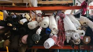 lot 79 image: Pallet Rack of 100s of Bulk Yards of Poly Blend Fabric Rolls Lot II