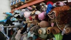 lot 80 image: Pallet Rack of 100s of Bulk Yards of Poly Blend Fabric Rolls Lot III