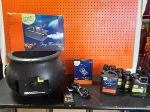 lot 1 image: Fog Machine With Timer, 6-Bottles Of Fog Juice & Cauldron With Cut Out