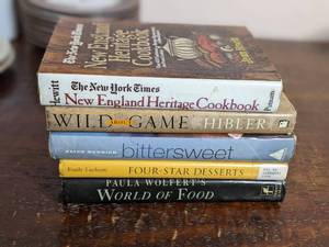 lot 79 image: Vintage Cookbooks-Paula Wolfers World of Food 1958 Wild About Game-1998 Bitter Sweet-Recipes & Tales From A Life in Chocolate 2003 Four-Star Desserts 1996 The New York Times New England Heritage Cookbook 1977
