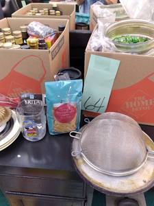 lot 64 image: Set of (2) Boxes Of Kitchen Supplies Cups, Olive Oil, Ware Ever, Light Globes, Etc. 
