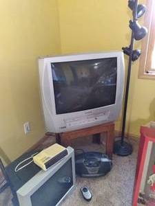 lot 17 image: So Many Electronics Panasonic TV, Emerson TV, Magnavox Clock Radio, Durabrand, Optimus, and an End Table with a Floor Lamp