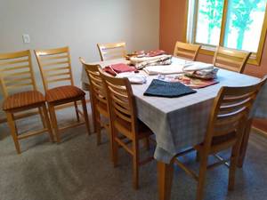 lot 57 image: High End Wood Counter Height Table and (8) Matching Chairs Along with the Linens and Place Settings