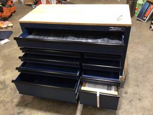 lot 16 image: Heavy-Duty 52 in. 9-Drawer Mobile Workbench with Adjustable-Height Solid Wood Top in Matte Blue by Husky Customer Returns See Pictures