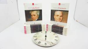lot 28 image: Round Battery Operated (Umbra) Quartz Clock From Canada--Twenty Two Books On Our Presidents