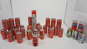 lot 98 image: A Collection Of Coca Cola Cans--One 7 Up Can--Four Pepsi Cans