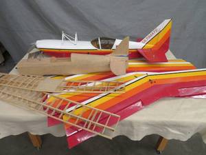 2 RC BALSA WOOD BI PLANES WITH A HUGE AMOUNT OF NEW PARTS AND PIECES.
