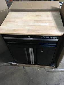 lot 38 image: Ready-to-Assemble 24-Gauge Steel 1-Drawer 2-Door Garage Base Cabinet in Black (28 in. W x 33 in. H x 18 in. D) by Husky Customer Returns See Pictures