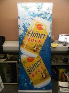 lot 18 image: SHINER BOCK - Retractable display banner stand  easy to set up and take down OR CAN BE HUNG - LARGE VERY COOL - APPROX 30 X 80 - SEE PICTURES