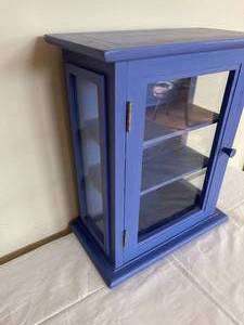 lot 105 image: Blue Wooden Two Shelf Display Piece With Glass Doors