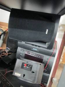 shelf of radios, speakers and turnt...