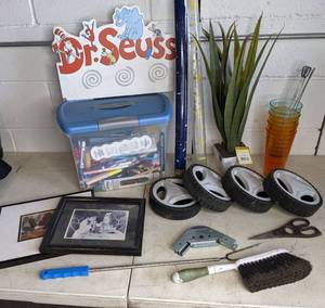 lot 24 image: Lot of Misc Items Framed Art, Wheels, Rain Gauge, Dr. Seuss Sign and More