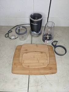 lot 10 image: Nutribullet with Accessories & (3) Wooden Cutting Boards