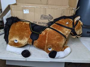 lot 576 image: Happy Trails Spring Horse Plush Ride-on Toy with Sounds