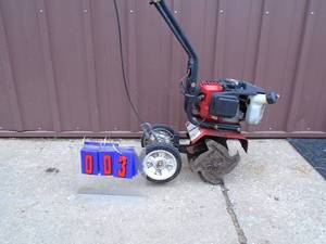 Earthquake mini tiller. Is missing rear depth arm. Runs good. As shown.