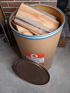 Cardboard Drum Full of Cut Firewood