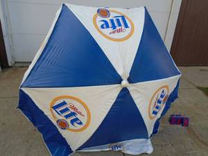 Miller Light vinyl patio umbrella with extension pole. As shown.