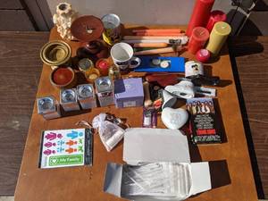 lot 42 image: Movies by Candlelight- Candles,  Candleholders, Young Guns VHS Tape, Vintage Precious Moments Candle, And More