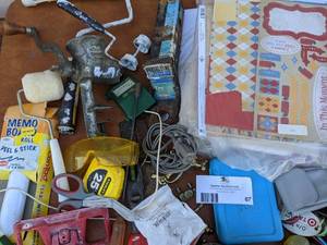 lot 67 image: Meat Grinder, Scrapbooking Pages, Tape Measure, Fasteners, Hitch Holder, And More Bundle