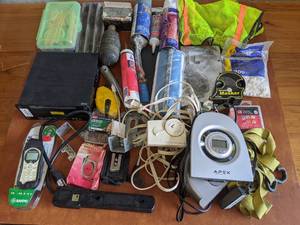 lot 31 image: Electronics and Tools Bundle-Caulk Pencils in Pencil Box Plumb Bob Apex DVD Player Minute Masker Modem  And More