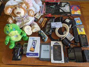 lot 32 image: Toy and Electronics Bundle-Vintage Toy Cars, Flashlight Friend, Funskins Lila Claire Bear, Nook, Cell Phones and More