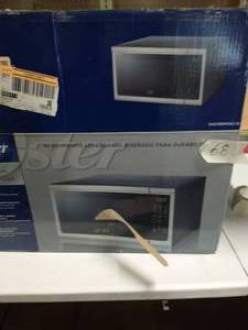 lot 68 image: Oster 1.1 cu ft 1000W Microwave - Stainless Steel