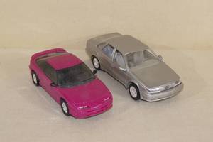 lot 100 image: 2 Plastic ERTL Scale Model Cars - Saturn, Taurus SHO