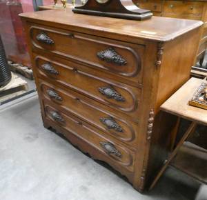 A Beautiful vintage solid wood dresser. 4 drawers with wonderfully ornate handles.