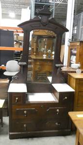This dramatic vanity makes quite the statement in your room. The white tops are marble.
