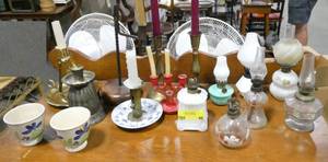 A table full of small lanterns.  A couple very old and unique.