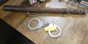 vintage handcuffs and billy club